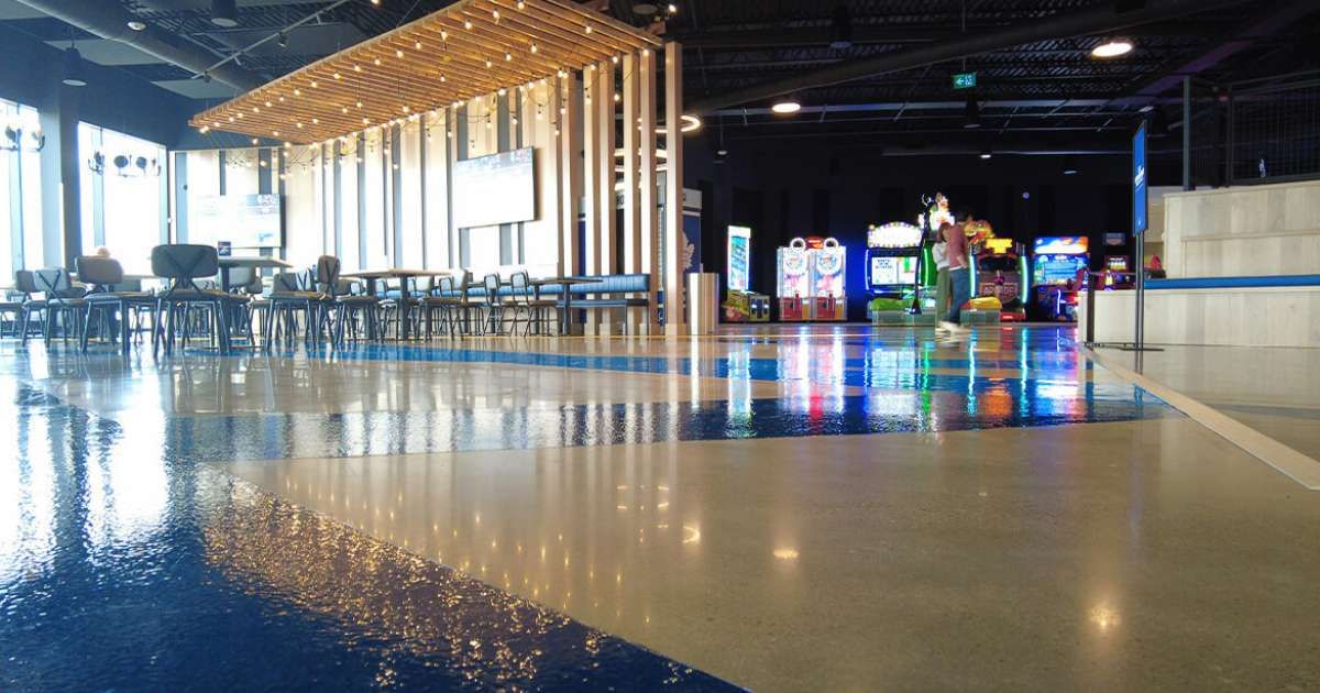 cineplex lobby with view of polished concrete floors 